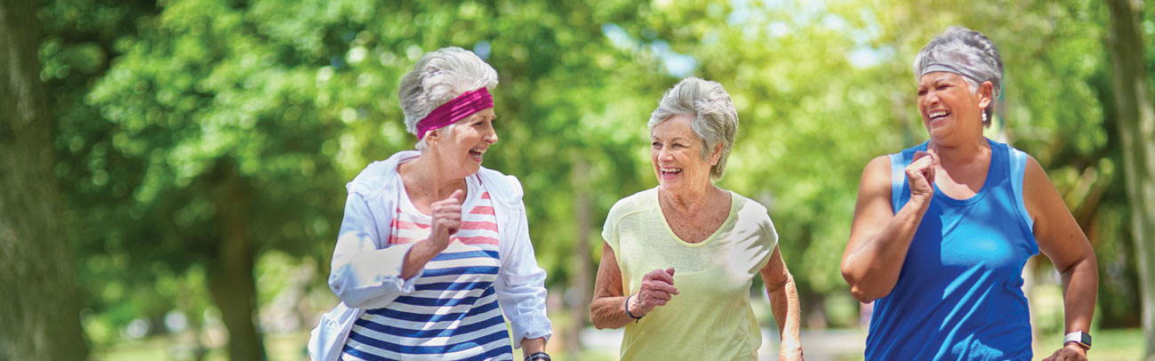 Three senior women jogging outdoors